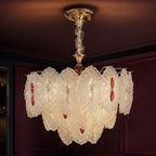 Rosette Glass Chandelier with Ruby Accents styled in a deep plum interior