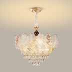 Feathered textured-glass chandelier with warm metal flourishes and crystal cascade