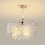 Floral bowl chandelier with broad veined glass petals and warm metal details