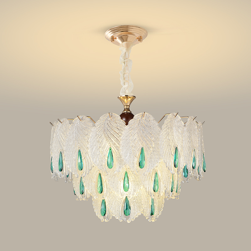 Layered clear glass leaf chandelier with elongated emerald-toned drops