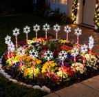 Red tube snowflake stake light with warm white glow in a winter garden - multi-set scene