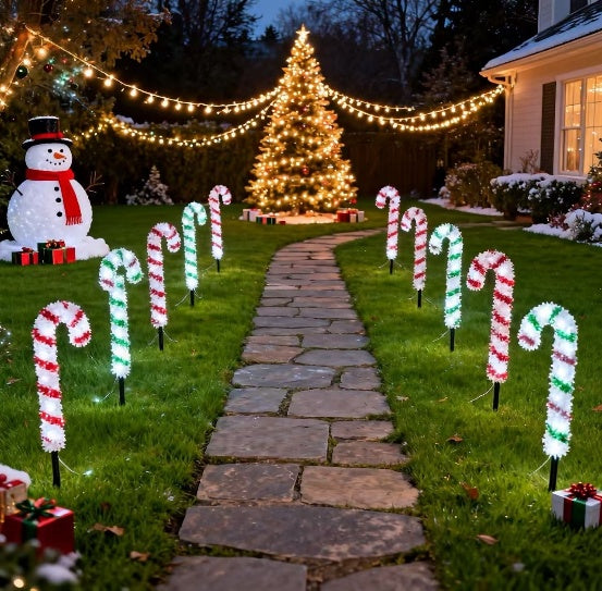Tinsel wrapped candy cane stake light glowing warm white - multi-set scene