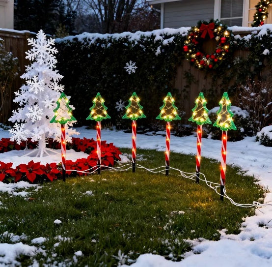 Red tube Christmas tree silhouette stake light glowing warm white outdoors - single-set scene